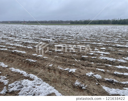 Pristine snow resting on a village field 121638422