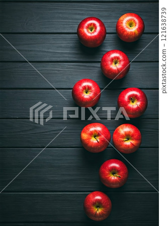 Apple close-up rendered on wooden board on dark background 121638739
