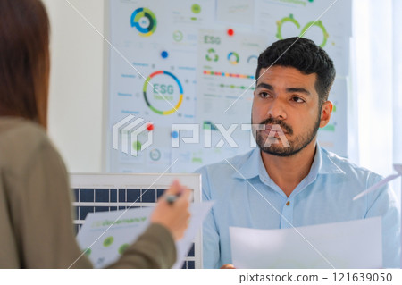 diversity team brainstorming discussion focused on ESG (environment,social,governance)  for sdgs goals in a sustainable green office 121639050