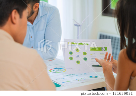 diversity team brainstorming discussion focused on ESG (environment,social,governance)  for sdgs goals in a sustainable green office 121639051