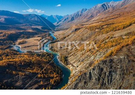 Scenic aerial view of a winding river through autumn mountain valley 121639480