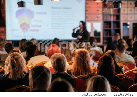 Audience Attending Business Presentation in Modern Conference Room 121639482