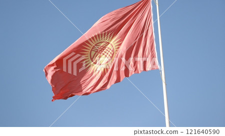 Kyrgyzstan flag is waving in Ala-Too Square against the blue sky 121640590