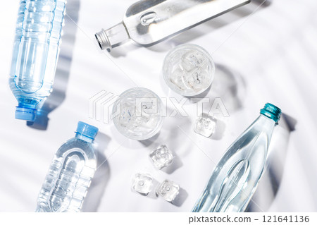 Crystal-clear glasses filled with chilled water and ice cubes Crystal-clear glasses filled with chilled water and ice cubes 121641136
