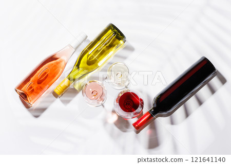Three wine glasses filled with red, white, and rose wine Three wine glasses filled with red, white, and rose wine 121641140
