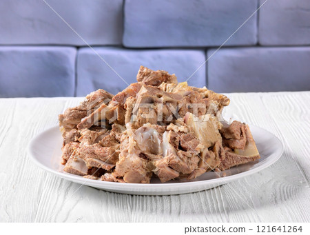 pork and beef bones with leftover meat after cooking broth on a white plate pork and beef bones with leftover meat after cooking broth on a white plate 121641264
