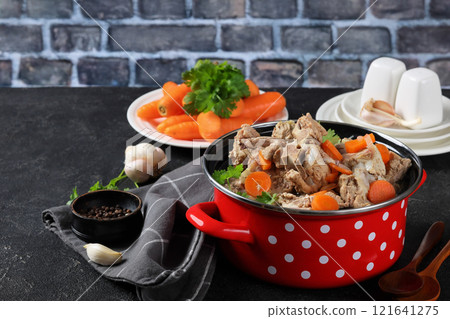 pot with broth, pork and beef bones and veggies pot with broth, pork and beef bones and veggies 121641275
