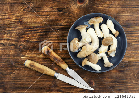 Uncooked champignon mushrooms in a bowl. Uncooked champignon mushrooms in a bowl. 121641355