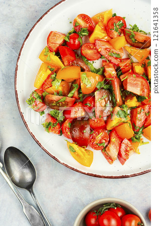 Salad of multi-colored tomatoes. 121641358