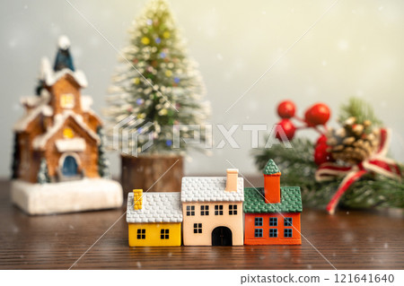 Miniature houses and Christmas trees. Merry Christmas and Happy New Year! Festive preparing for the xmas holidays. Town, city, real estate concept. 121641640