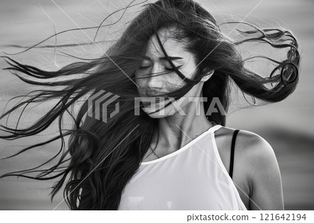 Serene Black and White Portrait of a Windswept Young Woman Serene Black and White Portrait of a Windswept Young Woman 121642194