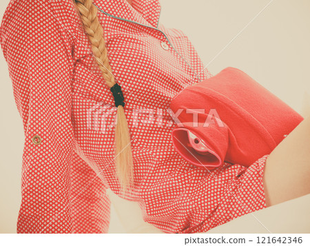 Woman feeling stomach cramps lying on bed Woman feeling stomach cramps lying on bed 121642346