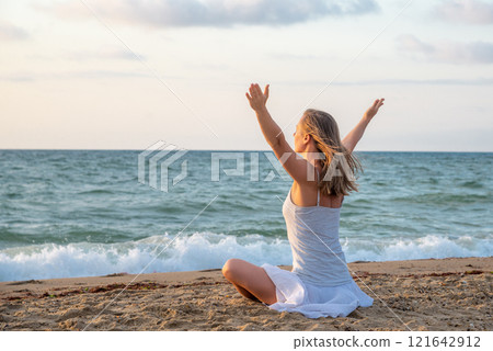 Woman meditating at the sea Woman meditating at the sea 121642912