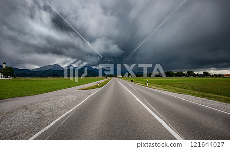 Road leading into a storm - Forggensee and Schwangau, Germany Bavaria Road leading into a storm - Forggensee and Schwangau, Germany Bavaria 121644027