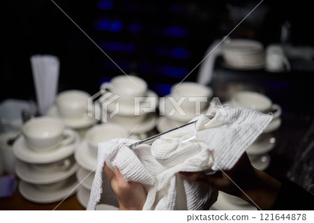 Cleaning glassware effectively in the fast paced environment of a bustling restaurant 121644878