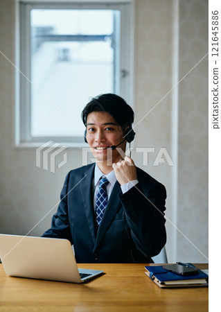 A young man in his 20s doing a fist pump A young man in his 20s doing a fist pump 121645886