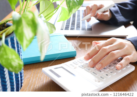 Woman using a calculator, accounting, expense image 121646422