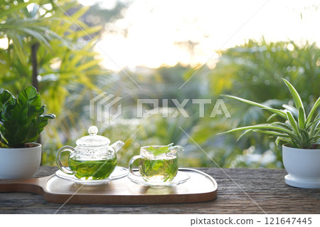 herbs tea, coriander, Lemon balm, Rice Paddy Herb in a glass teapot 121647445