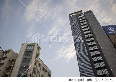Looking up at the sky from the valley of the building 121648060
