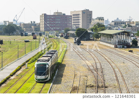 The circular light rail train drives past Hamasen Railway Cultural Park in Kaohsiung, Taiwan. The circular light rail train drives past Hamasen Railway Cultural Park in Kaohsiung, Taiwan. 121648301