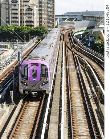 View of a Taoyuan International Airport line train running on the elevated track of the Taoyuan Mass Rapid Transit System. 121648304