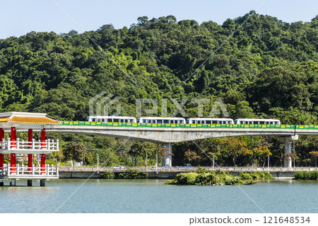 A train traveling on the Wenhu or Brown Line of the Taipei MRT, Taiwan, passes by Taipei Dahu Park. A train traveling on the Wenhu or Brown Line of the Taipei MRT, Taiwan, passes by Taipei Dahu Park. 121648534
