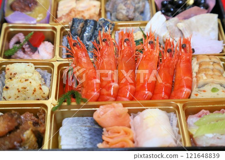 A luxurious New Year's Osechi meal from a luxurious restaurant, packed in a tiered box, and a colorful assortment of Japanese-style Kaiseki cuisine dishes A luxurious New Year's Osechi meal from a luxurious restaurant, packed in a tiered box, and a colorful assortment of Japanese-style Kaiseki cuisine dishes 121648839