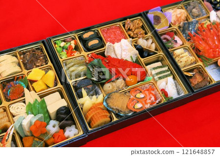 A luxurious New Year's Osechi meal from a luxurious restaurant, packed in a tiered box, and a colorful assortment of Japanese-style Kaiseki cuisine dishes A luxurious New Year's Osechi meal from a luxurious restaurant, packed in a tiered box, and a colorful assortment of Japanese-style Kaiseki cuisine dishes 121648857