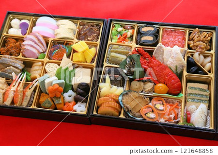 A luxurious New Year's Osechi meal from a luxurious restaurant, packed in a tiered box, and a colorful assortment of Japanese-style Kaiseki cuisine dishes A luxurious New Year's Osechi meal from a luxurious restaurant, packed in a tiered box, and a colorful assortment of Japanese-style Kaiseki cuisine dishes 121648858