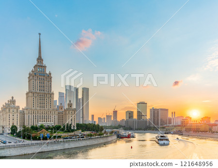 High-rise stalinist building near river at summer sunset in Moscow, Russia. Historic name is Hotel Ukraine. 121648956