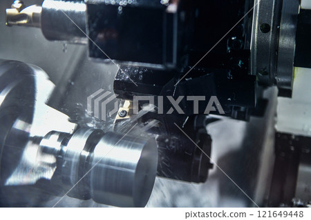 Cutting steel metal shaft processing on lathe machine in workshop, metalworking industry 121649448