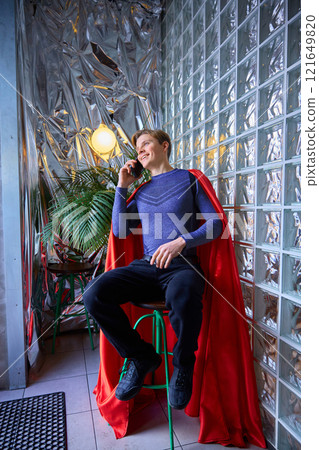 Superhero-styled man smiles warmly, while talking in phone, blending casual communication with extraordinary presence, within reflective, futuristic surroundings. Superhero-styled man smiles warmly, while talking in phone, blending casual communication with extraordinary presence, within reflective, futuristic surroundings. 121649820