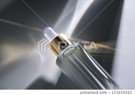 Bottle of face serum with a pipette with a beautiful highlight. 121650583