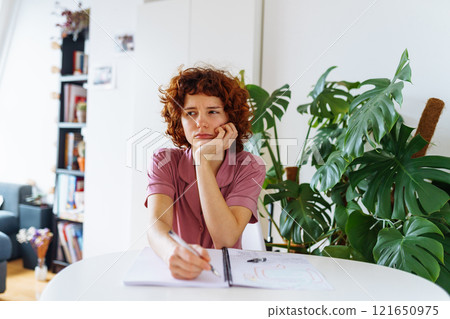 homeschooling, woman writing notes in notebook homeschooling, woman writing notes in notebook 121650975