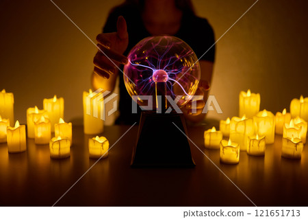 Experience a Mystical Scene with an Energy Ball and Candles, evoking Spiritual Vibes 121651713