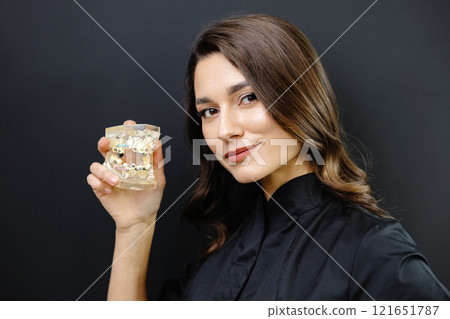 Orthopedic dentist doctor is holding teeth 3d printed model of the patient's jaw with malocclusion 121651787
