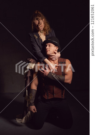 Retro woman with man in vintage wear holding each other Retro woman with man in vintage wear holding each other 121652061