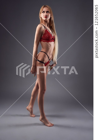 Slim woman in red underwear 121652065