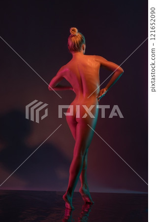 Naked sensual woman standing back with drawn hair on wet surface in studio Naked sensual woman standing back with drawn hair on wet surface in studio 121652090