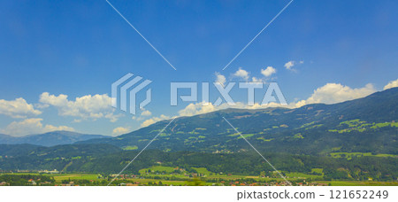 Wonderful wooded mountain alpine panorama with village and huts Austria. 121652249