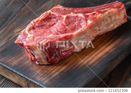 Raw Cowboy Steak with Marbling on Wooden Board, Ready to Cook 121652306