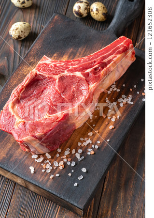 Raw Cowboy Steak with Marbling on Wooden Board, Ready to Cook 121652308