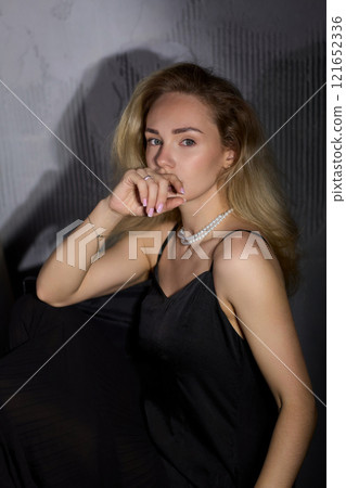 An Elegant Woman in a Beautiful Black Dress Posing Elegantly with Grace and Charm An Elegant Woman in a Beautiful Black Dress Posing Elegantly with Grace and Charm 121652336