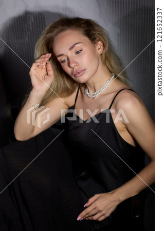 An Elegant Woman in a Beautiful Black Dress Posing Elegantly with Grace and Charm An Elegant Woman in a Beautiful Black Dress Posing Elegantly with Grace and Charm 121652337