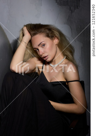 An Elegant Woman in a Beautiful Black Dress Posing Elegantly with Grace and Charm An Elegant Woman in a Beautiful Black Dress Posing Elegantly with Grace and Charm 121652340