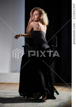An Elegant Woman in a Beautiful Black Dress Posing Elegantly with Grace and Charm 121652347