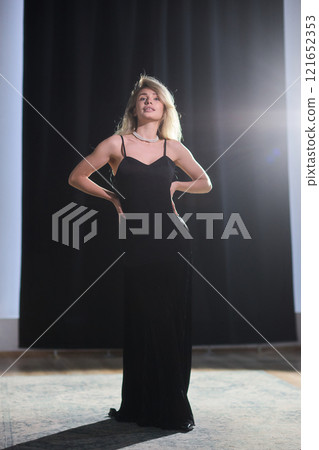 An Elegant Woman in a Beautiful Black Dress Posing Elegantly with Grace and Charm An Elegant Woman in a Beautiful Black Dress Posing Elegantly with Grace and Charm 121652353