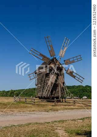Old windmill on blue sky background Old windmill on blue sky background 121652460