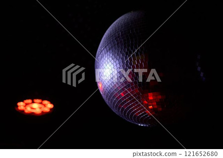 A Disco Ball Shining Red Light, Creating an Energetic Atmosphere Perfect for Celebrating 121652680