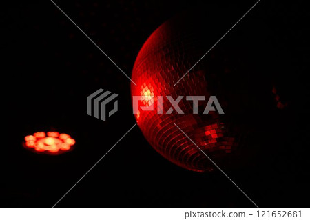 A Disco Ball Shining Red Light, Creating an Energetic Atmosphere Perfect for Celebrating 121652681